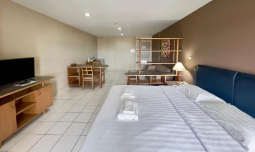 a bedroom with a large bed and a television at BU Place Hotel in Bangkok