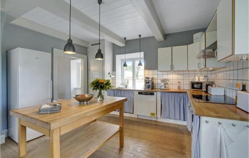 a kitchen with a wooden table in the middle at Holiday Home Højslev 40 in Bøstrup