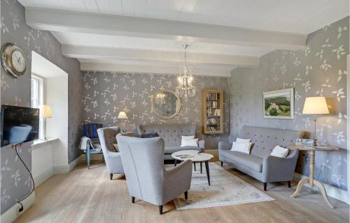 a living room with a couch and chairs and a table at Holiday Home Højslev 40 in Bøstrup