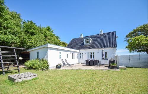 a white house with a yard and a fence at 3 Bedroom Stunning Home In Tranekær in Tranekær