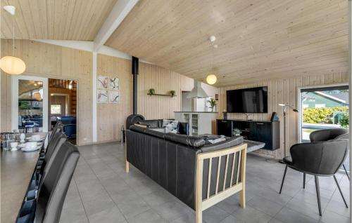 a living room with a couch and a tv at Beautiful Home In Idestrup With Sauna in Bøtø By