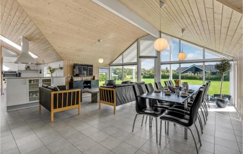 a kitchen and dining room with a table and chairs at Beautiful Home In Idestrup With Sauna in Bøtø By