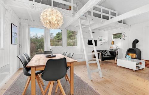 a dining room with a table and a loft bed at Three-Bedroom Holiday Home In Sydals in Skovbyballe