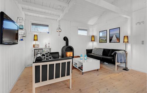 a living room with a couch and a fireplace at Three-Bedroom Holiday Home In Sydals in Skovbyballe