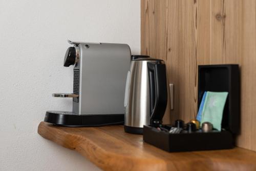 a coffee maker sitting on top of a wooden shelf at AvenidA Panorama Suites in Kaprun
