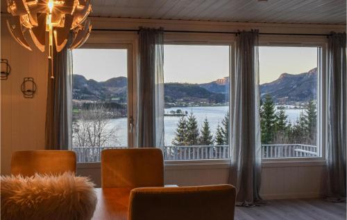 a dining room with a table and a view of the water at 5 Bedroom Pet Friendly Home In Eiken in Eiken