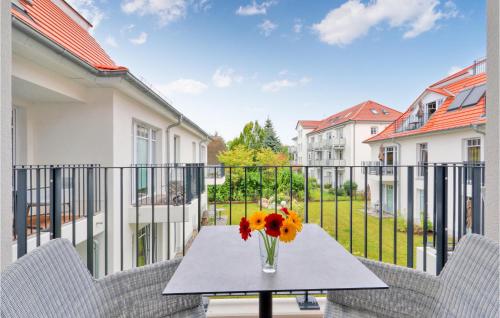 a vase of flowers on a table on a balcony at Baltischer Hof Apartment 35 in Boltenhagen