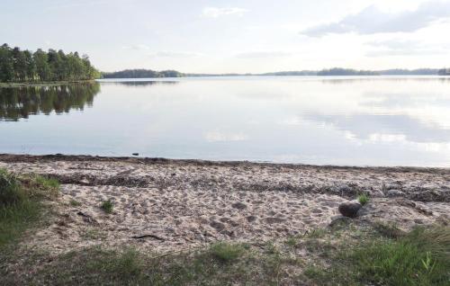 a view of the shore of a lake at Stunning Home In Lidhult With Lake View in Lidhult