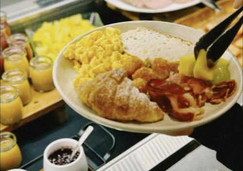 a plate of breakfast food on a table at Sudima Auckland City in Auckland