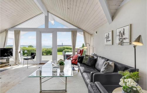 a living room with a couch and a table at Holiday Home Havremarken Sjølund Ii in Hejls