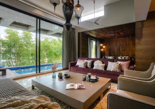 a living room with a couch and a table at Lohono Stays Villa Bamboo Breeze in Khandala