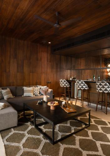 a living room with a couch and a table at Lohono Stays Villa Bamboo Breeze in Khandala