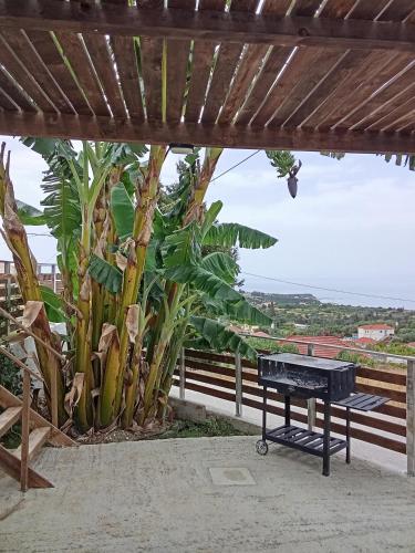 a picnic table under a pergola with a view of the ocean at villa kate view in Ratzaklíon