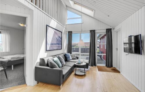 a living room with a couch and a tv at Stunning Home In Thisted With Sauna in Klitmøller