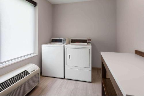 a laundry room with a washer and dryer and a window at Holiday Inn Express Hotel & Suites Dubois by IHG in DuBois