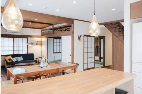 a living room with a table and a couch at Lampstand STAY Sapporo-House A in Sapporo
