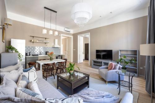 a living room with a couch and a table at Charming Central Dream Home & Retreat by Prestige Homes in Budapest