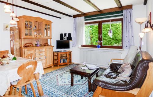 a living room with a couch and a table at 1 Bedroom Beautiful Apartment In Arrach in Arrach