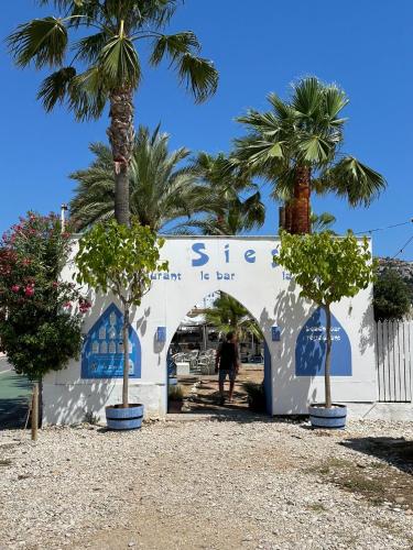 a white building with palm trees in front of it at Casa deBoer in Jávea