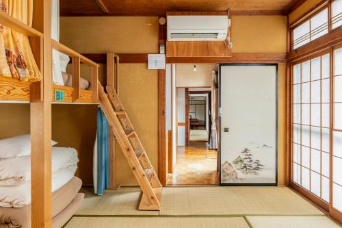 a room with bunk beds and a hallway at Entire House Popotel One in Matsumoto