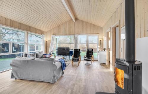 a living room with a couch and a fireplace at Holiday Home Sandleddet Højby Ii in Lumsås