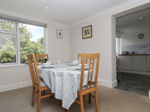 a dining room with a table and four chairs at Godrevy in Penzance