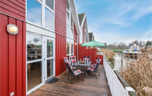 a wooden deck with a table and chairs on it at Gorgeous Home In Wendisch-Rietz in Wendisch Rietz