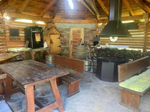 a kitchen with a table and a stove in a cabin at Ubytování pod Rozhlednou in Velké Karlovice
