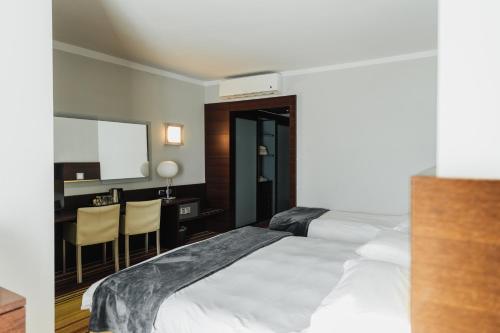 a hotel room with a bed and a desk at Hotel Bel Sit in Meina