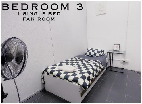 a bedroom with a bed and a fan at Harris Homestay Gerik Town, Free Wifi & Netflix in Gerik