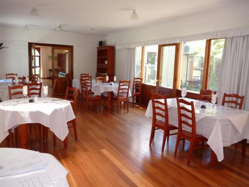 a restaurant with tables and chairs with white tablecloths at Tranquilles Bed & Breakfast in Port Sorell