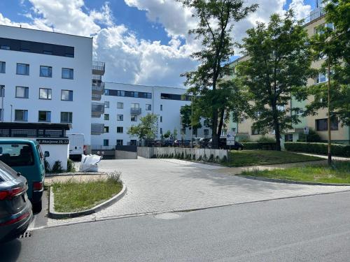 a parking lot in front of a building at Apartament Akacjowa in Gollnow