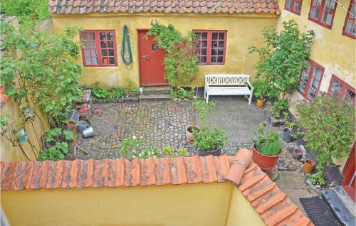 a view of a garden with a bench in front of a house at Holiday Home Assens 7 in Assens