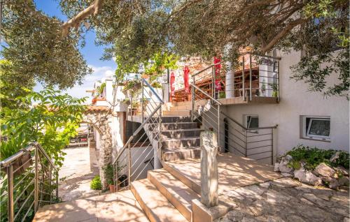 a set of stairs leading up to a building at Beautiful Apartment In Stara Baska 1 in Stara Baška