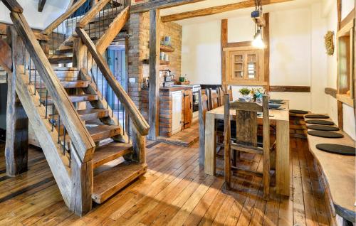 a kitchen with wooden stairs and a dining room at Awesome Home In Popovaca in Popovača