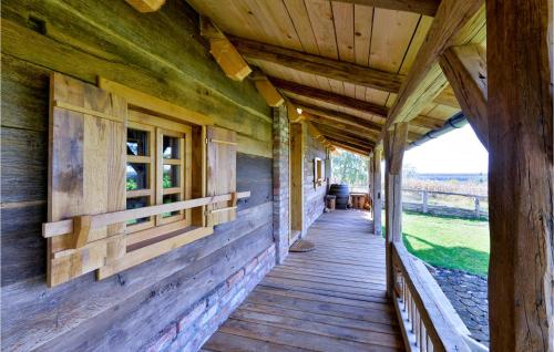 a wooden porch of a log cabin with a window at Awesome Home In Popovaca in Popovača