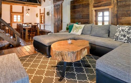 a living room with a couch and a tree stump coffee table at Awesome Home In Popovaca in Popovača