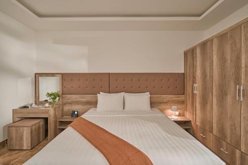 a bedroom with a large bed with wooden cabinets at California Hotel in Da Lat