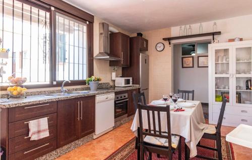a kitchen with a table with a tablecloth on it at Gorgeous Home In Torrox With Wifi in Torrox