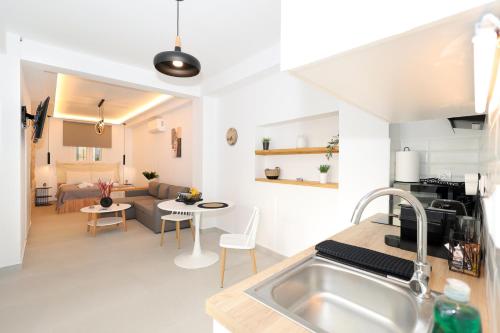 a kitchen and living room with a sink and a couch at Lalos Apartment in Aegina Town