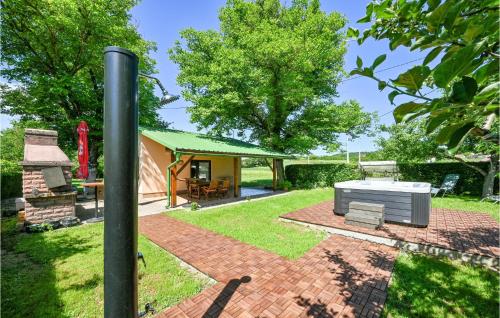 a house with a brick patio with a stove at Studio Holiday Home In Galovic Selo in Galović-Selo