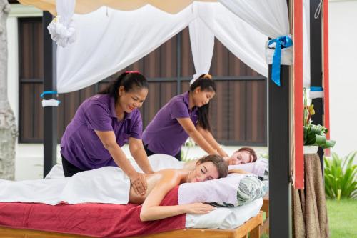 a group of women laying on a bed at The Briza Beach Resort, Samui - SHA Plus in Chaweng