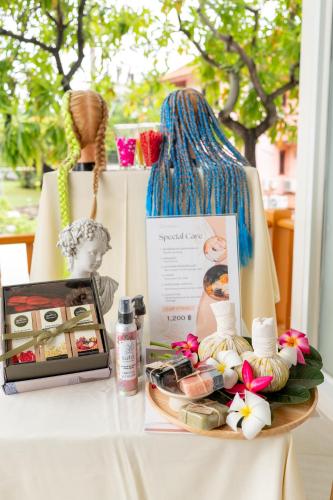 a table with a tray of cosmetics and a bag at The Briza Beach Resort, Samui - SHA Plus in Chaweng