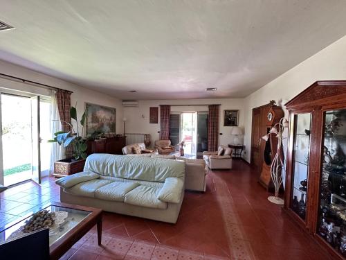 a living room with a couch and a table at Villa Garden in Sabaudia