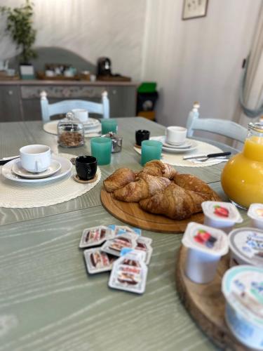 a table with croissants and pastries on it at Villa Garden in Sabaudia