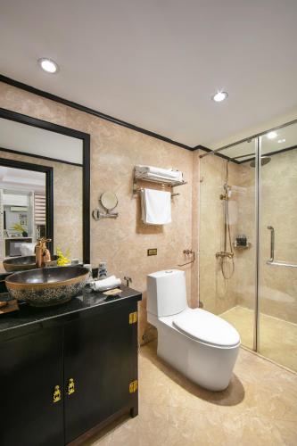 a bathroom with a toilet and a sink and a shower at Lavender Central Hotel & Spa Hanoi in Hanoi
