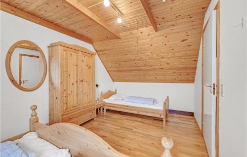a bedroom with a bed and a mirror in a room at Stunning Home In Nyborg With Sauna in Nordenhuse