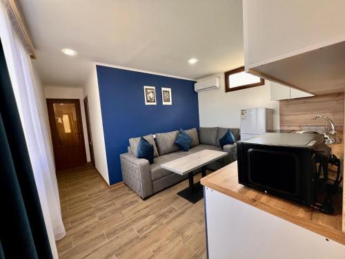 a living room with a couch and a kitchen at Luxury Cottage next to observatory in Byurakan