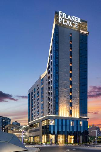 a large building with a sign on top of it at Fraser Place Wujiaochang Shanghai - Adjoin business center, free minibar in Shanghai