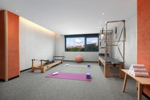 a room with a gym with a treadmill and a pilates at Fraser Place Wujiaochang Shanghai - Adjoin business center, free minibar in Shanghai